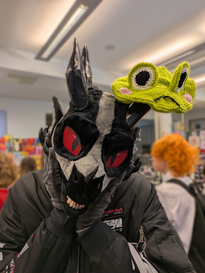 Me wearing a lizard cosplay and having a green silly frog hat on my head.. Or horn. Either way.