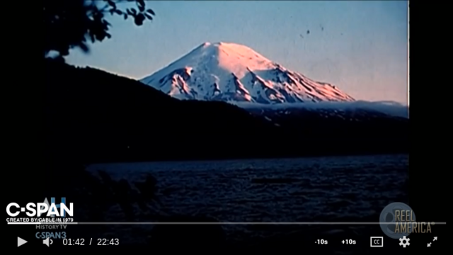 screenshot of opening scene of Mt St Helens eruption film by USFS showing the snow-capped conical peak before the eruption. The film is now available in the C-SPAN archive.